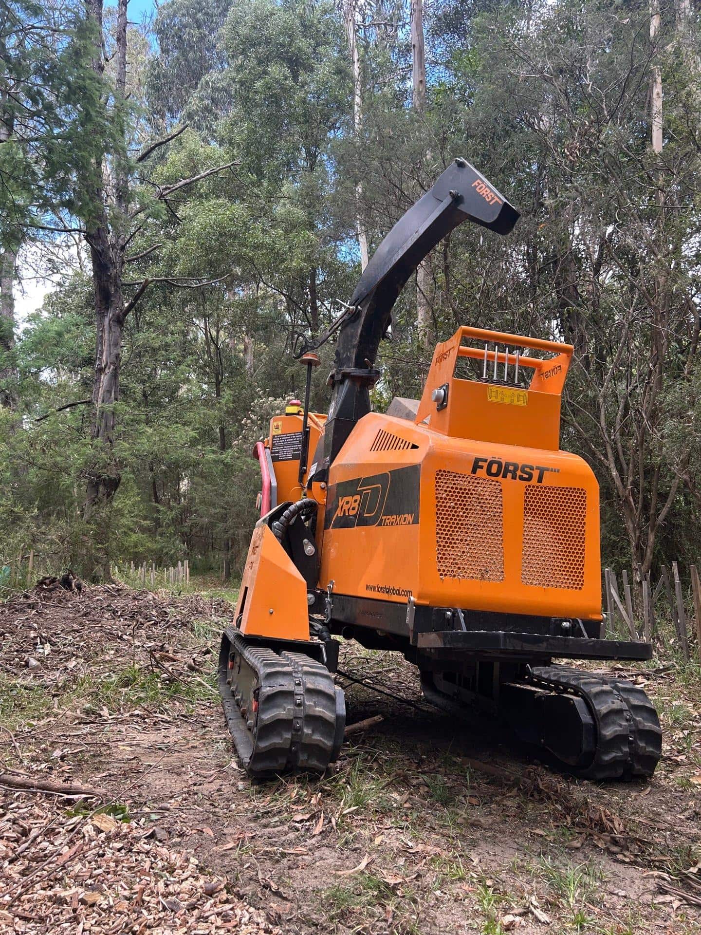 Professional grounds maintenance technician using battery-powered Terra Maintenance equipment